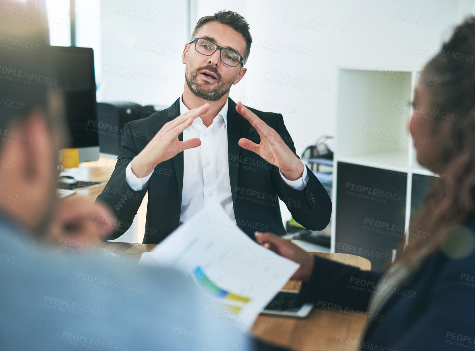 Buy stock photo Cropped shot of a group of corporate colleagues sitting in the boardroom during a meeting