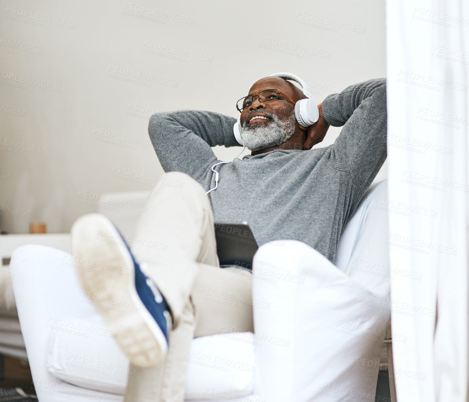 Buy stock photo Senior black man, relax and listening to music, podcast or jazz on radio in living room. Headphones, retirement and happy person streaming audio, sound or vintage playlist on tablet in home on sofa