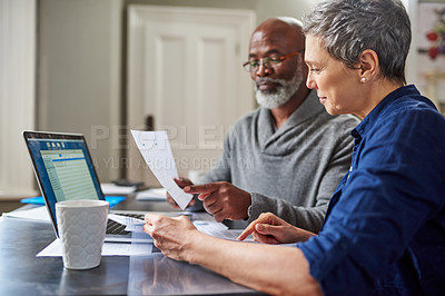 Buy stock photo Laptop, documents and finance with a senior couple busy on a budget review in the home together. Accounting, taxes or investment planning with a mature man and woman looking at insurance or savings 