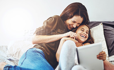 Buy stock photo Funny, mother and kid on tablet in bed at home together for game, relax and family streaming comedy movie. Happy girl, mom and technology in bedroom for meme, laughing or reading joke on app online