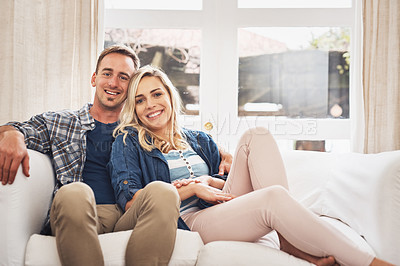 Buy stock photo Portrait of a young couple relaxing on the couch at home