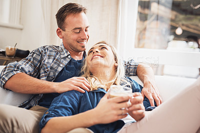 Buy stock photo Shot of a young couple relaxing on the couch at home
