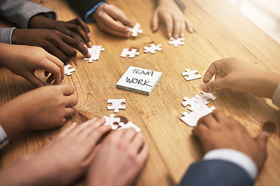 Buy stock photo Teamwork, puzzle and hands of business meeting for brainstorming in a meeting together planning strategy at work. Circle, jigsaw and professional group of people at a table working on innovation
