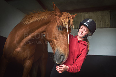 Buy stock photo Shot of a teenage girl bonding with her horse