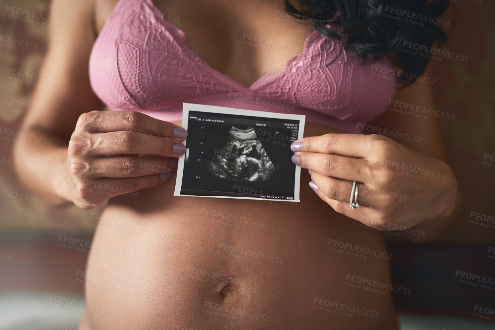 Buy stock photo Cropped shot of an unrecognizable pregnant woman standing in her bedroom at home