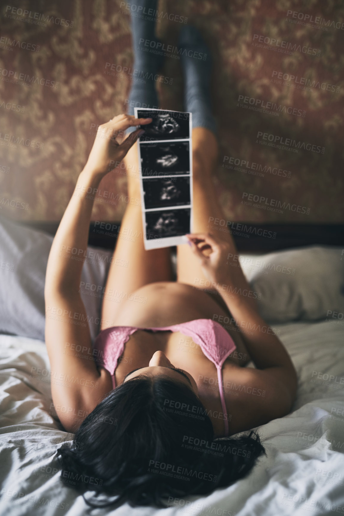 Buy stock photo Home, bed and pregnant woman with sonogram of ultrasound, progress and growth for baby development. Bedroom, female person or stomach with fetus scan for pregnancy, motherhood or wellness in lingerie