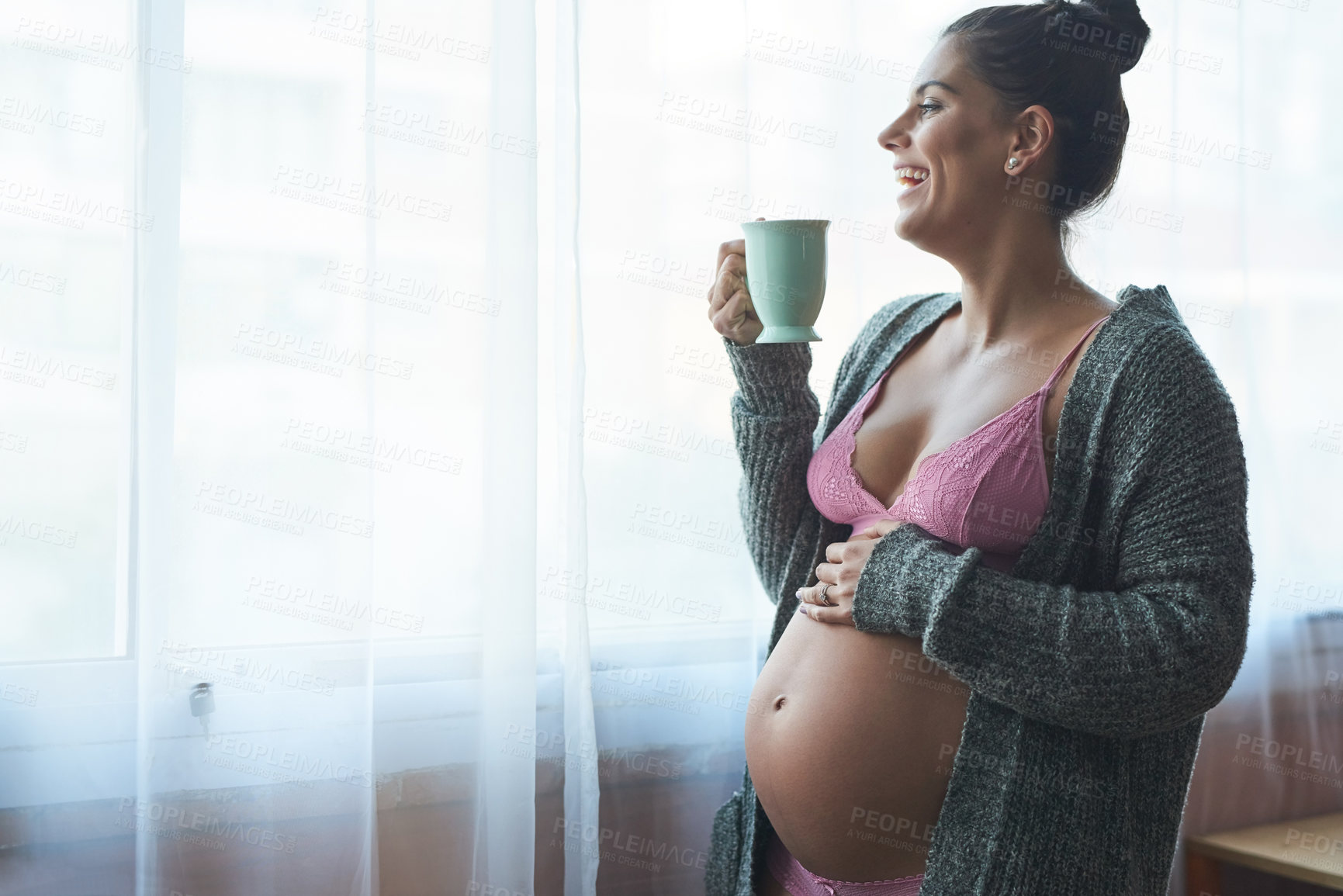 Buy stock photo Home, tea and pregnant woman with stomach for touching, feeling or growth for baby development. Beverage, female person or lingerie with laugh for motherhood, pregnancy or connect with fetus by space