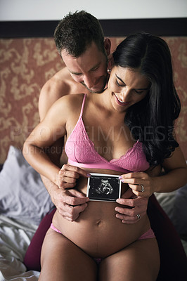 Buy stock photo Pregnancy, couple and ultrasound in bedroom for love, announcement and gender reveal. Future parents, pride and woman in underwear for growth, maternity and happy for picture with baby update in home