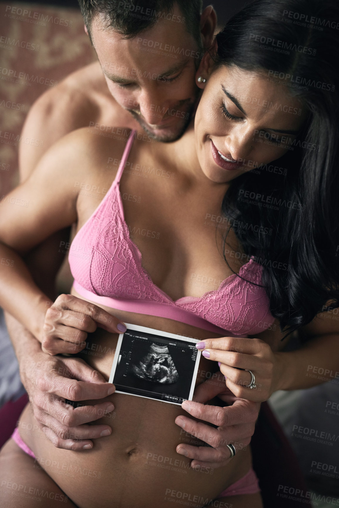 Buy stock photo Pregnancy, couple and ultrasound in home for love, announcement and gender reveal. Future parents, pride and woman in underwear for growth, maternity and happy for picture with baby update in bedroom