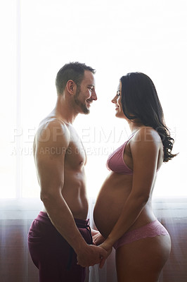 Buy stock photo Couple, pregnant woman and holding hands in bedroom for prenatal care, bonding and love of pregnancy development. Man, wife and stomach with lingerie, healthy maternity and passion together at house