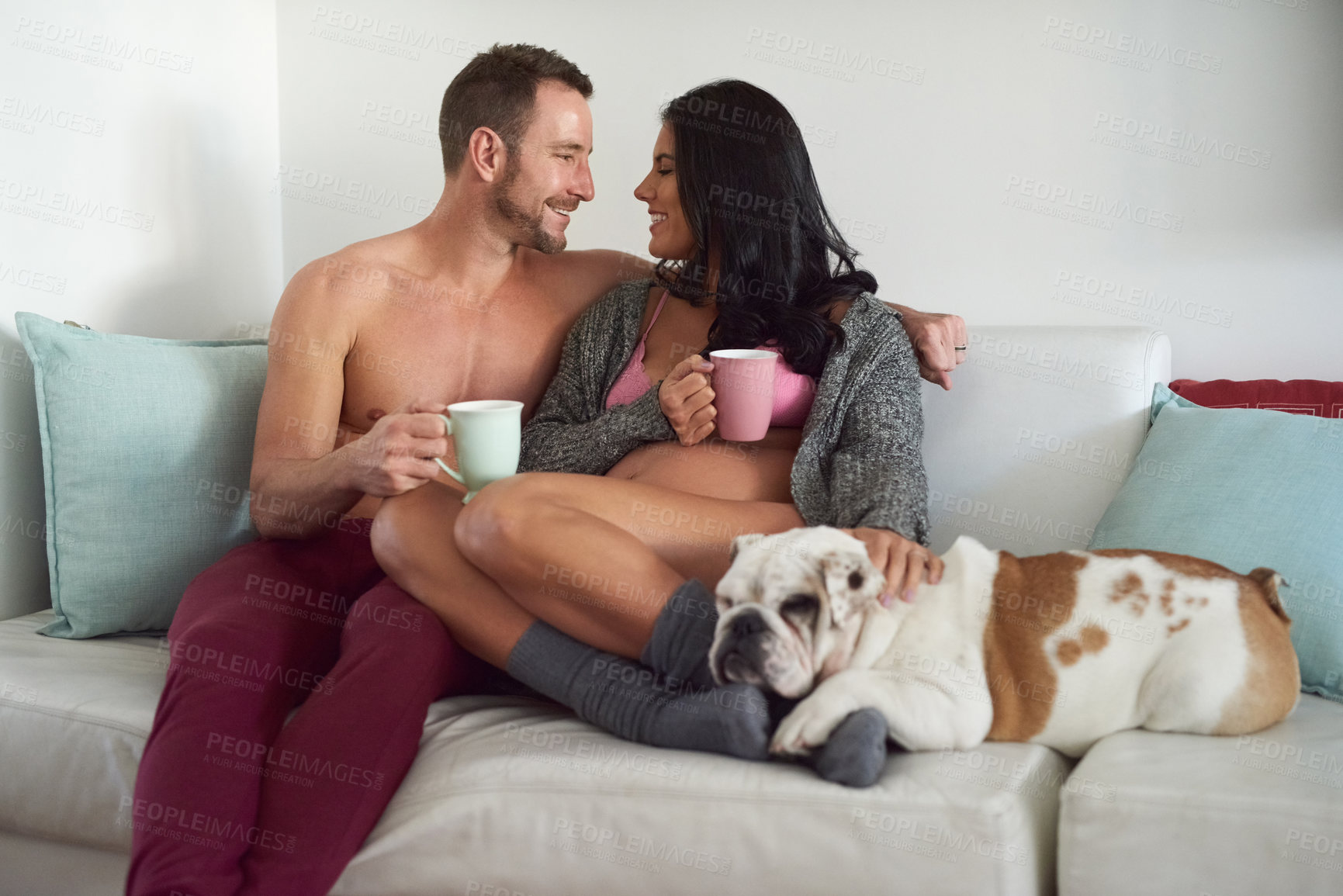 Buy stock photo Couple, pregnant woman and coffee break in living room for prenatal care, bonding and love of pregnancy development. Man, wife and hug with underwear, healthy maternity and family together at house