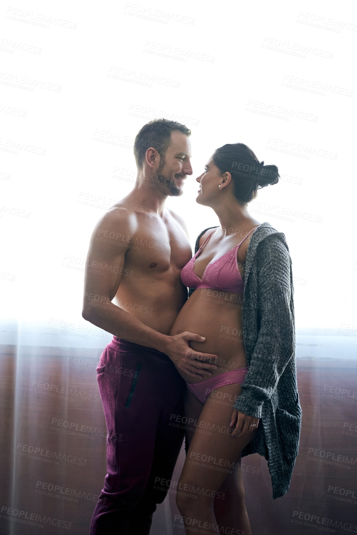 Buy stock photo Man, pregnant woman and belly touch in bedroom for prenatal care, bonding and love of pregnancy development. Couple, wife and stomach with underwear, healthy maternity and family intimacy at house