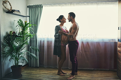 Buy stock photo Man, pregnant woman and dance in bedroom for prenatal care, bonding and love of pregnancy development. Couple, wife and stomach with underwear, healthy maternity and family intimacy at house