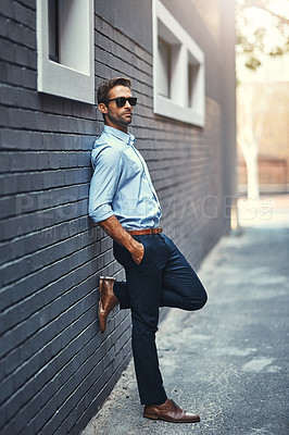 Buy stock photo Realtor, brick and wall with sunglasses, confident and vision with urban person. Real estate agent, startup and business with property, style and formal or professional aesthetic for job fashion
