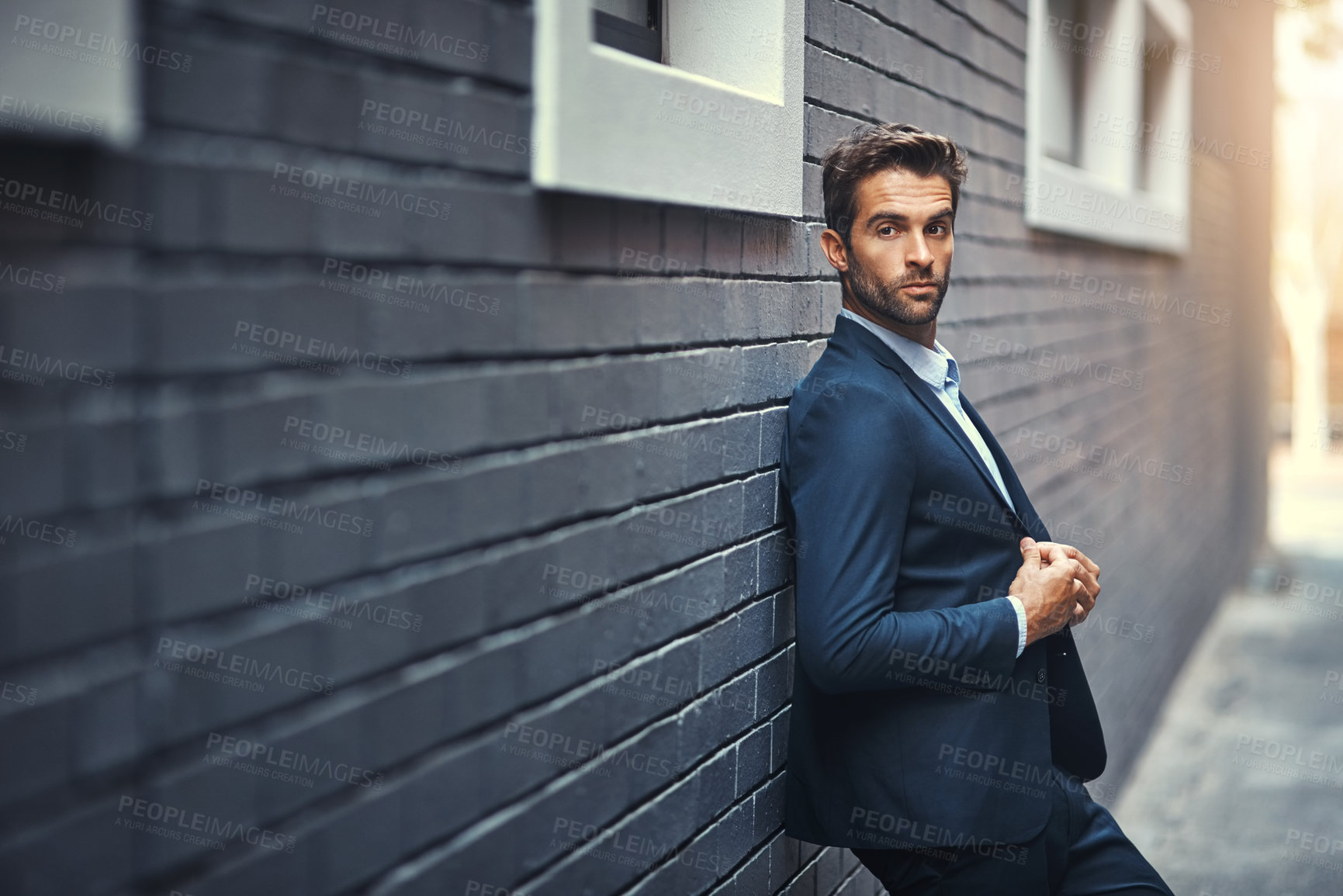 Buy stock photo Fashion, businessman and thinking in city by wall with corporate style, trendy and sophisticated suit. Male entrepreneur, professional and confident in street for travel, work or company and outdoor.