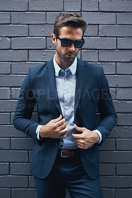 Buy stock photo Stylish, man and wall in suit with sunglasses for fashion, style and trendy in outdoor. Male person, pride and confidence in street for work, corporate or career in men's wear in grey background