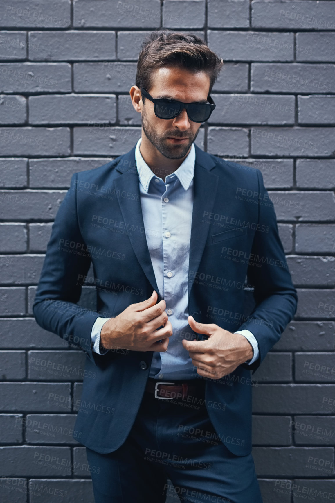 Buy stock photo Stylish, man and wall in suit with sunglasses for fashion, style and trendy in outdoor. Male person, pride and confidence in street for work, corporate or career in men's wear in grey background