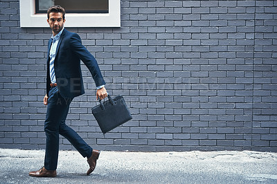 Buy stock photo Man, walking and brick wall in city for business with briefcase, work commute, and corporate company. Male executive, bag and urban background for banking career with travel, professional and street