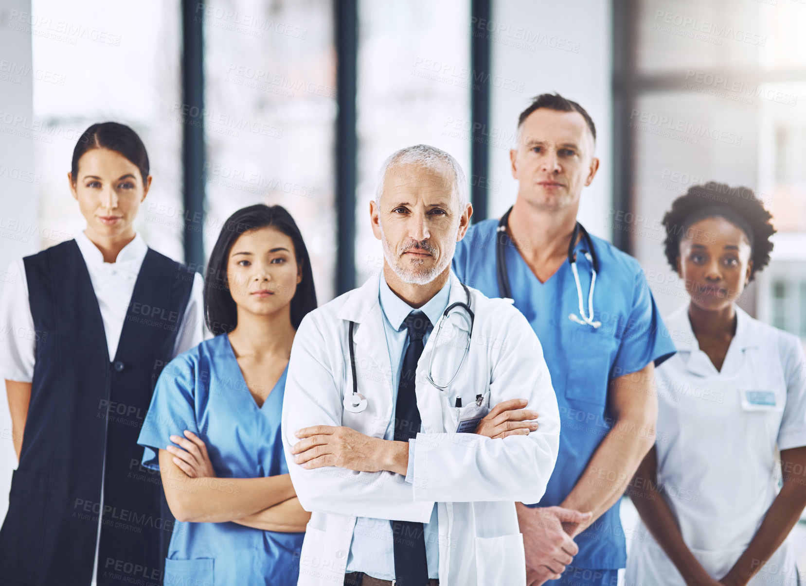 Buy stock photo Team, senior doctor and portrait of nurses and doctors in hospital, support and teamwork in healthcare. Health care, diversity and medicine, confident leader and group of medical employees together.