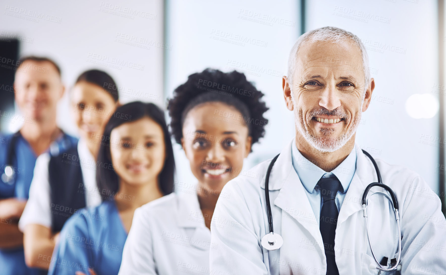 Buy stock photo Smile, team and portrait of senior doctor with nurses in hospital, leadership and teamwork in healthcare. Health, diversity and confident doctors in group and happy medical employees in row together.