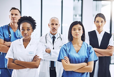 Buy stock photo Medical, crossed arms and portrait of group of doctors standing in the hallway with confidence. Serious, diversity and team of professional healthcare workers in a medicare clinic or hospital.