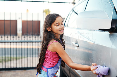Buy stock photo Washing car, happy and child with water, home chores and cleaning. Smile, routine and a little girl with happiness while learning to clean transport in the driveway for polishing with responsibility