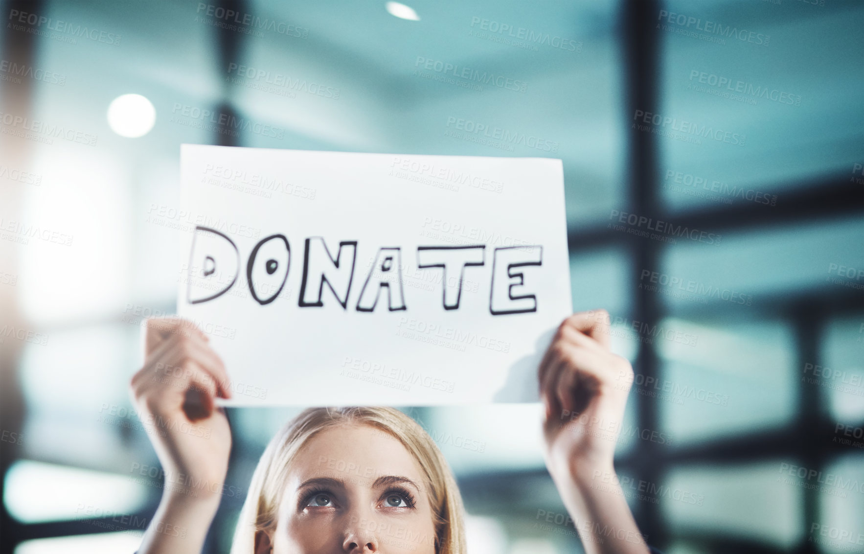 Buy stock photo Donate, volunteer and give back to the community with a sign in the hands of a young woman inside. Closeup of a poster with text looking for welfare aid, donations and contributions to society