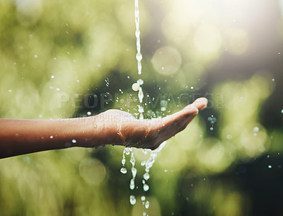Buy stock photo Hygiene, washing and saving water with hands against a green nature background. Closeup of one person holding out their palm to save, conserve and refresh with water in a park, garden or backyard