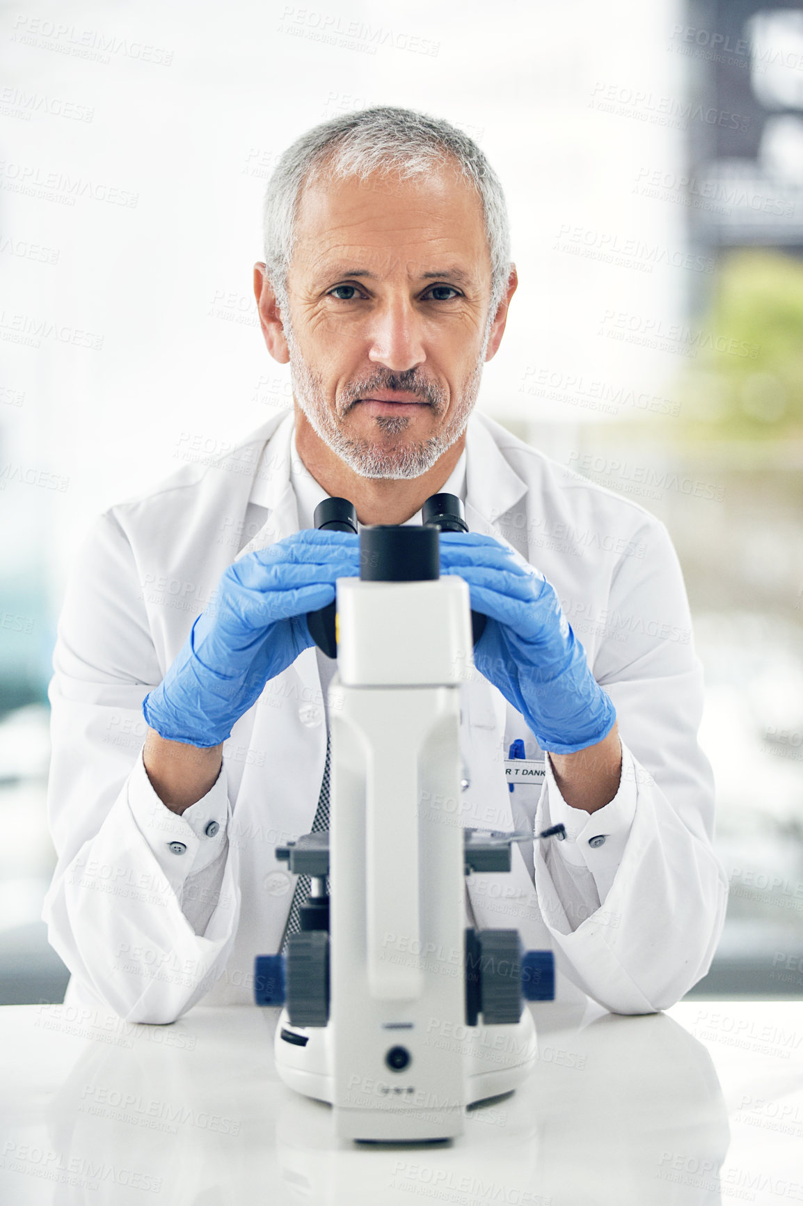 Buy stock photo Senior man, microscope and portrait of scientist in forensic science, breakthrough or discovery at laboratory. Serious male person, medical or healthcare professional in scientific research at a lab