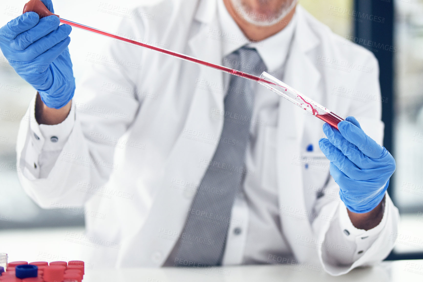 Buy stock photo Cropped shot of a scientist conducting an experiment