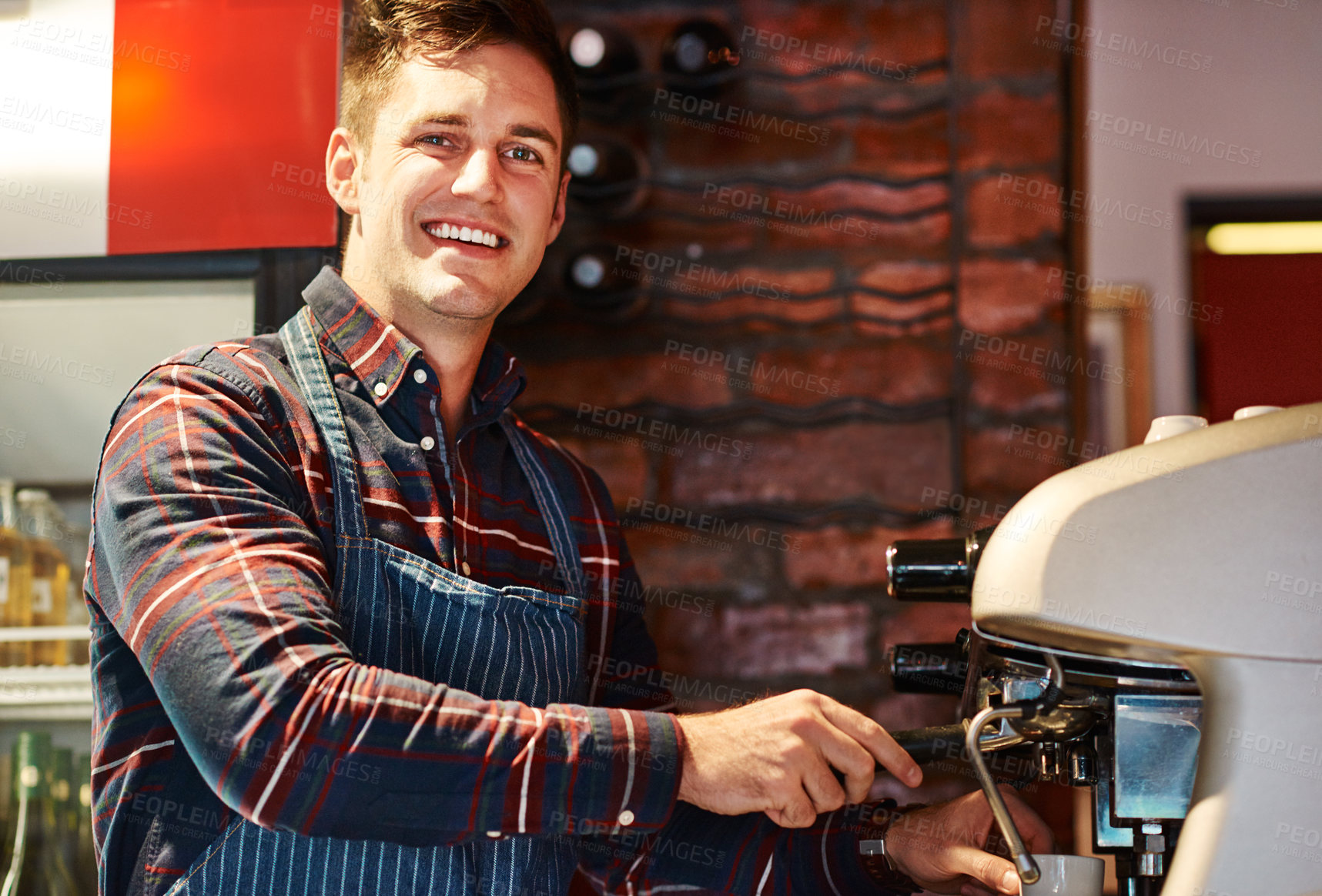 Buy stock photo Portrait of a barista operating a coffee machine in a cafe