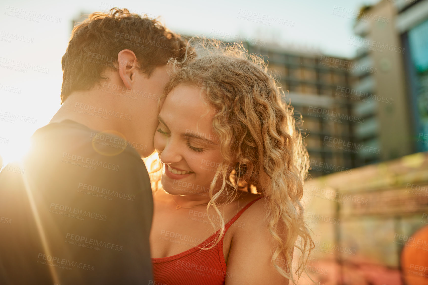 Buy stock photo Happy couple, hug and kiss with love in city for embrace, romance or affection together. Young man, woman or lovers with smile or compassion for initmacy, support or relationship in an urban town