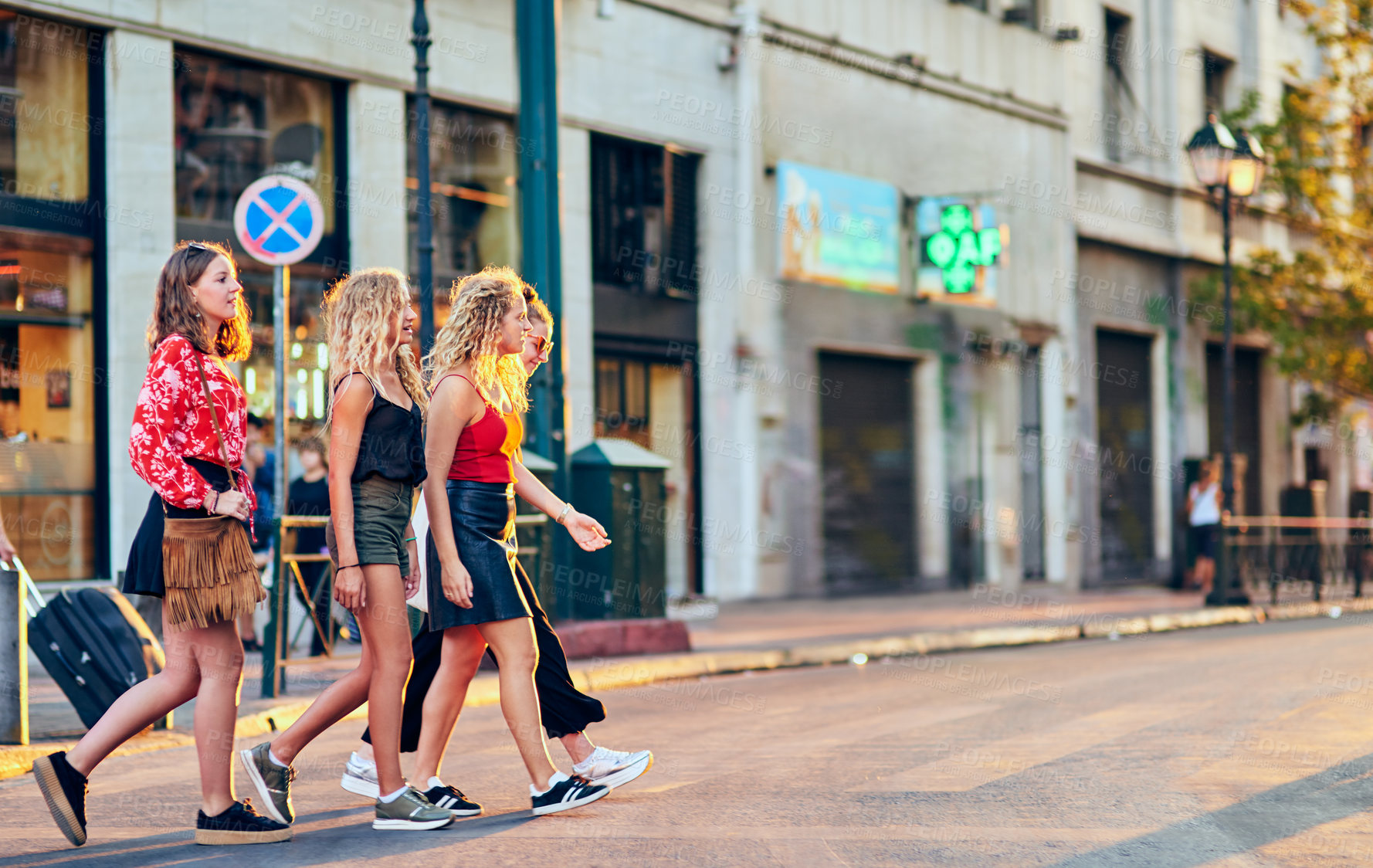 Buy stock photo Full length shot of a group of attractive young girlfriends taking a walk through the city