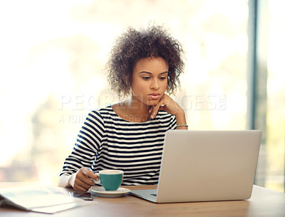 Buy stock photo Cropped shot of an attractive young businesswoman working on her laptop at home