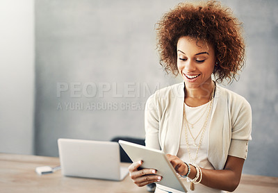 Buy stock photo Cropped shot of an attractive young businesswoman working on her tablet at home