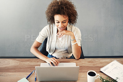 Buy stock photo High angle shot of an attractive young businesswoman working on her laptop at home