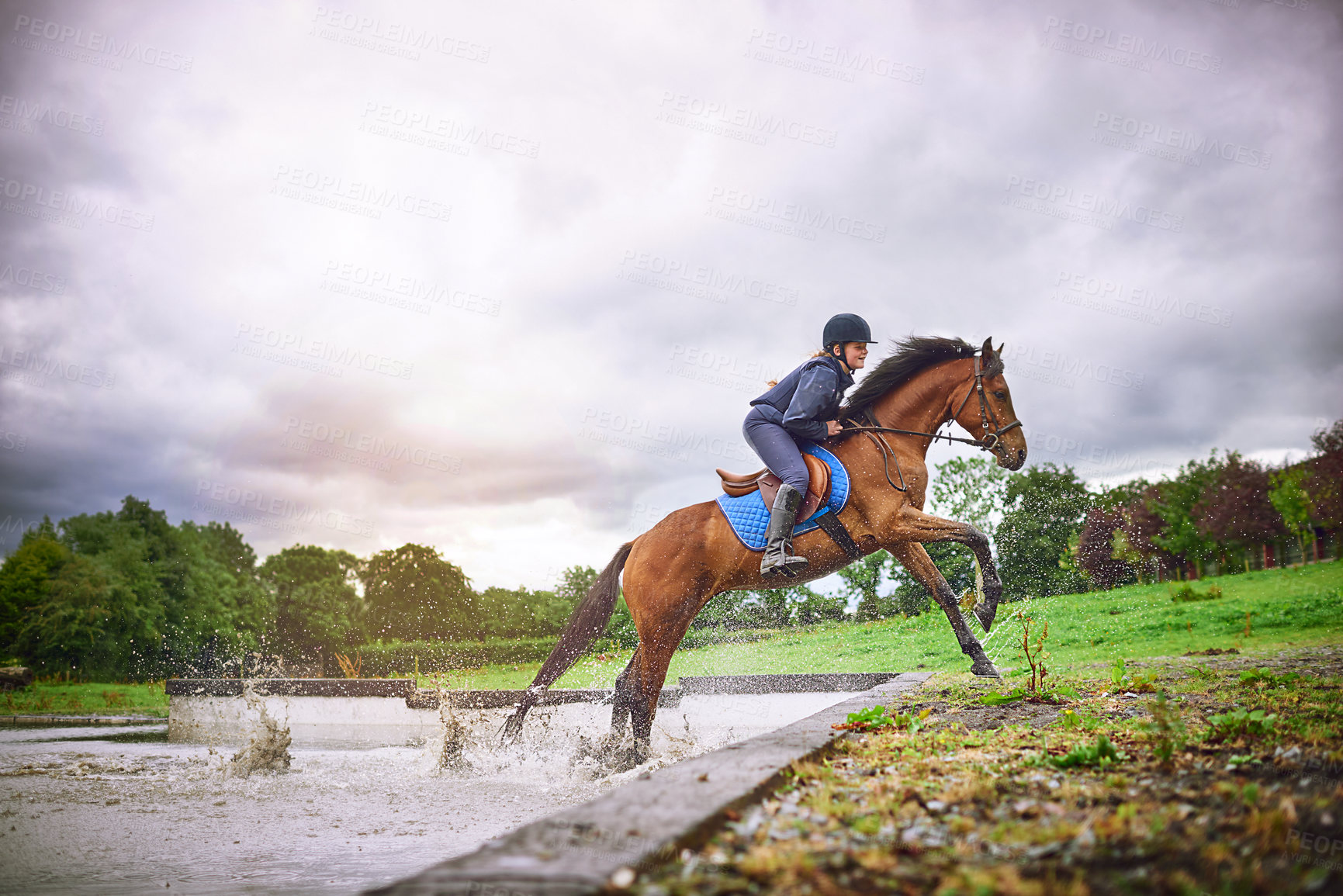 Buy stock photo Equestrian girl, splash and horse in action, running and outdoor for sport hobby, fun and bonding for show. Teen jockey, animal and happy with countryside, farm and ranch riding together for care