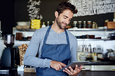 Buy stock photo Small business, cafe and man with tablet checking review, online booking or reservation in coffee shop. Reading, tech and restaurant manager, waiter or owner with digital app for service industry POS