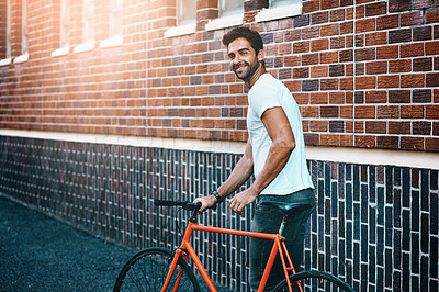 Buy stock photo Happy, bicycle and portrait of man by brick wall in city for sightseeing on vacation or adventure. Smile, walking and male person with bike in town street on weekend trip or holiday in Netherlands.