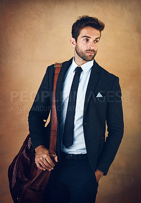 Buy stock photo Bag, vision and confident man with clothes for fashion, style and formal wear isolated on brown background. Male person, gentleman and businessman in trendy outfit, class or suit in studio backdrop