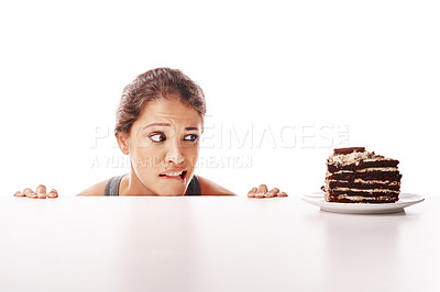 Buy stock photo Hungry, temptation and a woman with chocolate cake on a table isolated on a white background in a studio. Unhealthy, sneaky and a young lady looking at a dessert while on a diet or healthy lifestyle