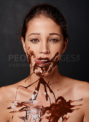 Buy stock photo Woman, portrait and lick with chocolate melt in studio for body art, confidence and creative aesthetic. Model, person and serious with candy sauce on black background for skincare and cosmetics