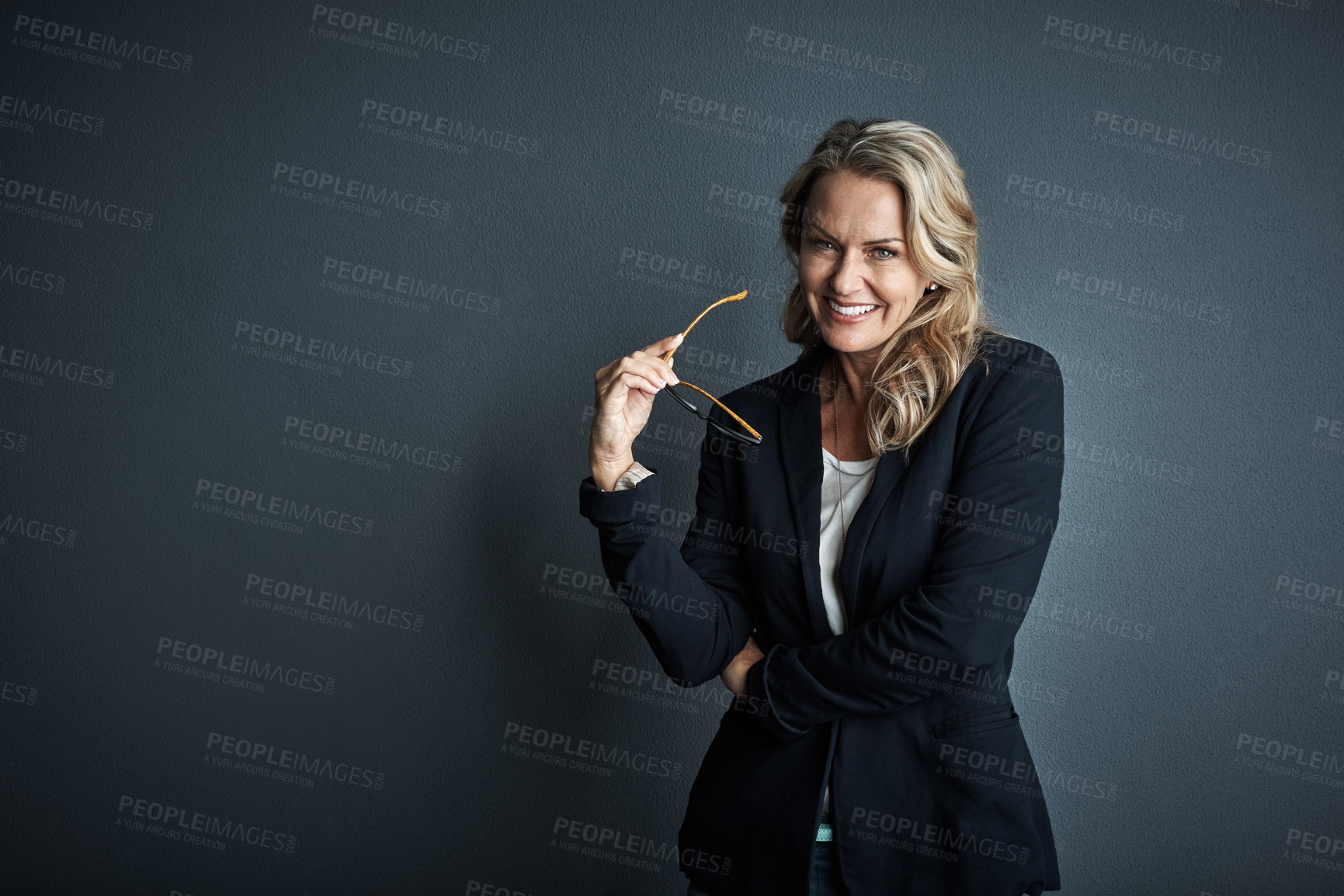 Buy stock photo Studio portrait of a mature businesswoman posing against a grey background