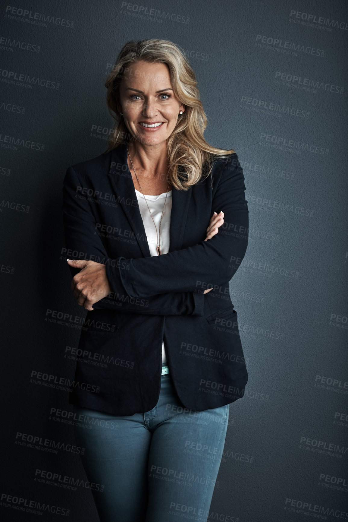 Buy stock photo Studio portrait of a mature businesswoman posing against a grey background