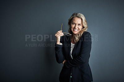 Buy stock photo Studio portrait of a mature businesswoman posing against a grey background