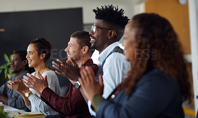 Buy stock photo Shot of a group of businesspeople applauding during a presentation in an office
