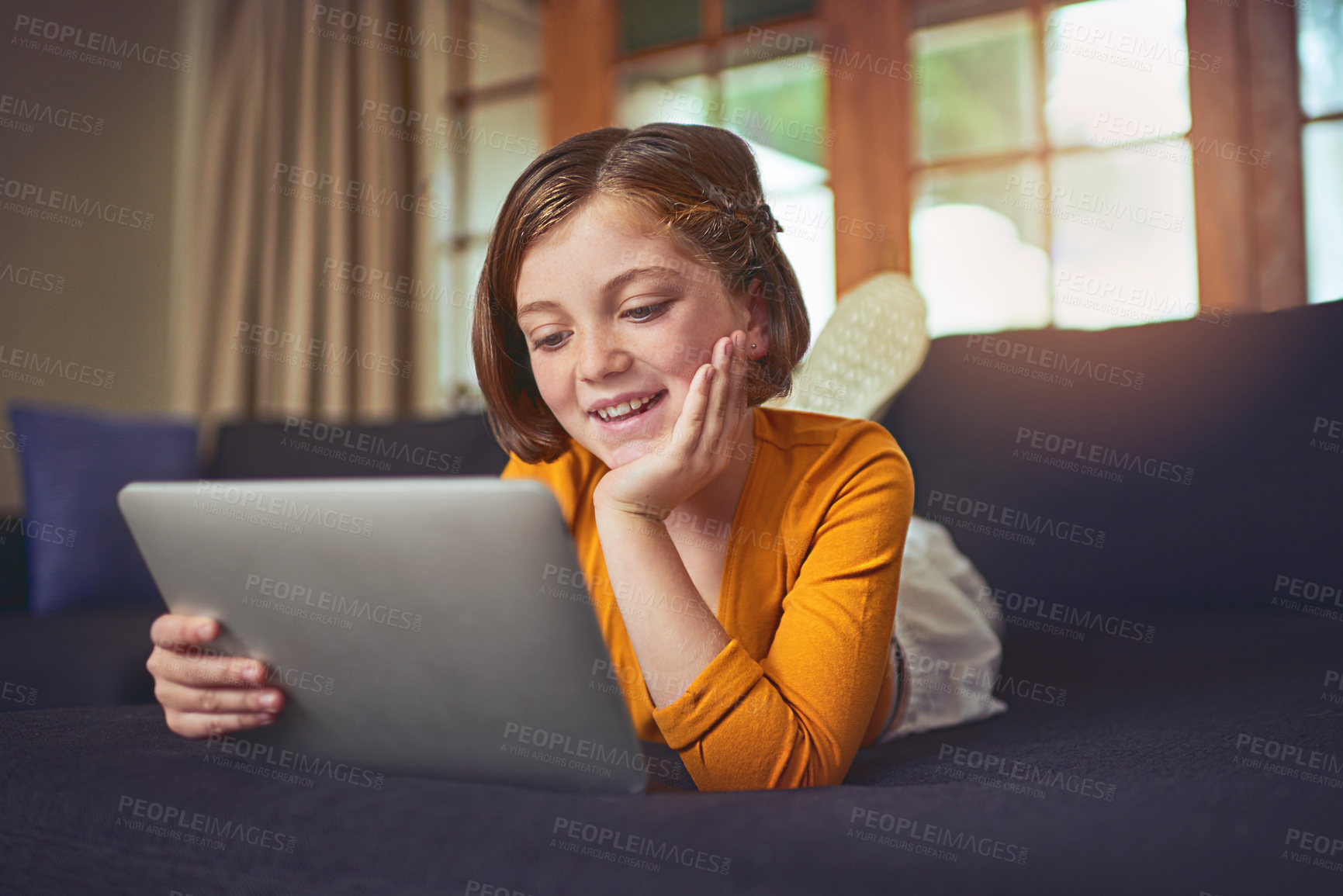 Buy stock photo Shot of an adorable little girl using a digital tablet on the floor at home