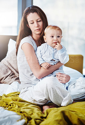 Buy stock photo Tired, wake up and a mother with her baby in the bedroom of their home in the morning as a single parent. Family, children and an exhausted young woman sitting on the bed with her infant son