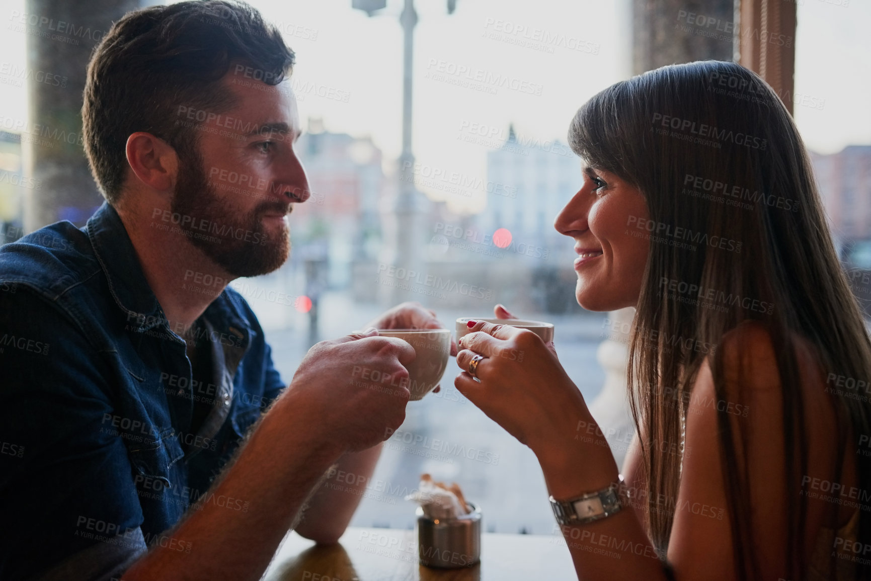 Buy stock photo Coffee shop, happy and couple in conversation with drink, caffeine beverage and cappuccino in cafe. Dating, love and man and woman relax in restaurant for bonding, relationship and romance on weekend
