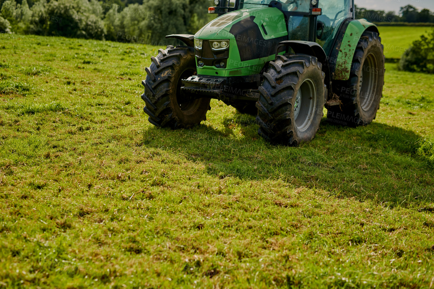 Buy stock photo High angle shot of a green tractor on an open piece of farmland
